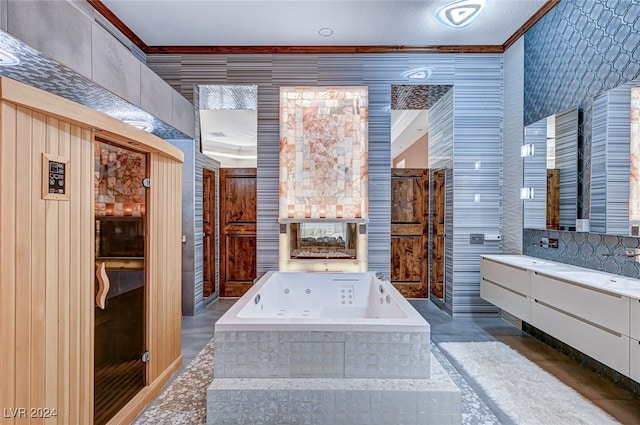 bathroom with ornamental molding, vanity, and tiled tub