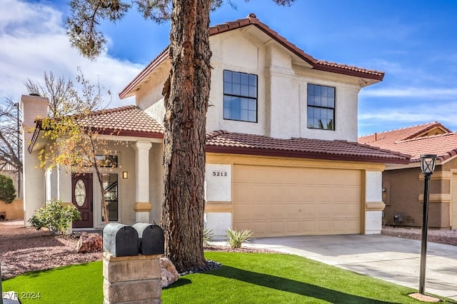 mediterranean / spanish-style house with a garage