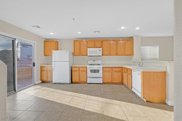 kitchen featuring sink, white appliances, and light tile patterned floors