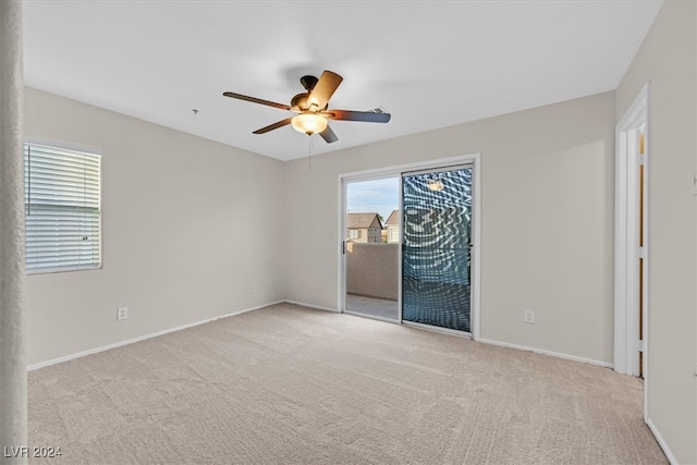 spare room featuring ceiling fan and light colored carpet