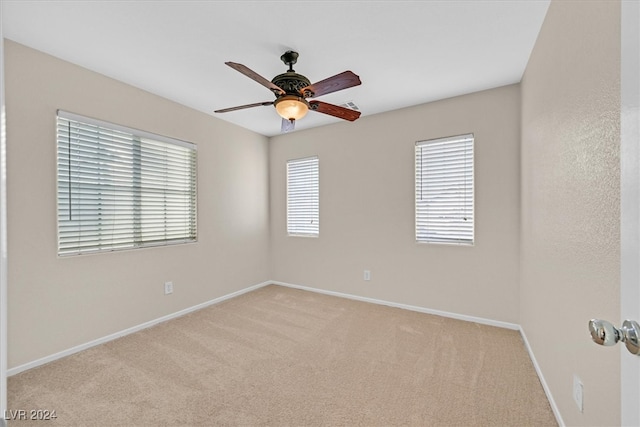 empty room with light colored carpet and ceiling fan