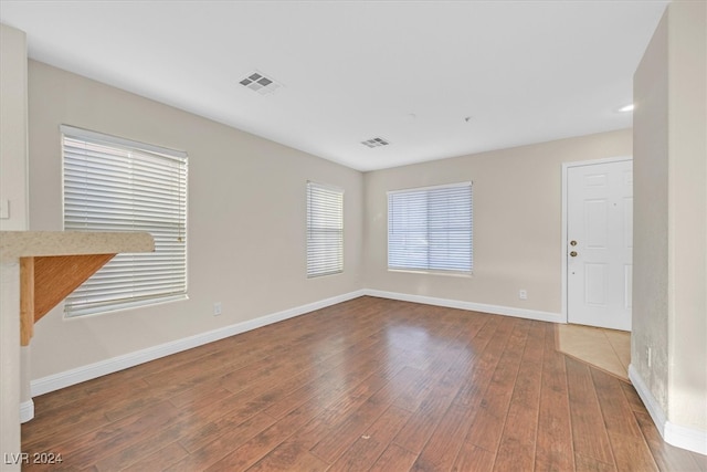 empty room with hardwood / wood-style floors