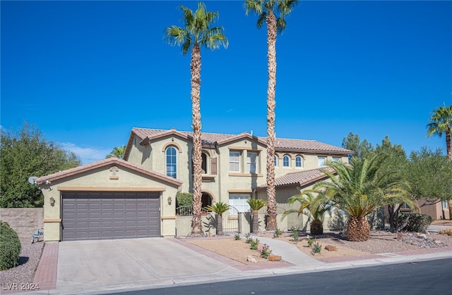 mediterranean / spanish house with a garage