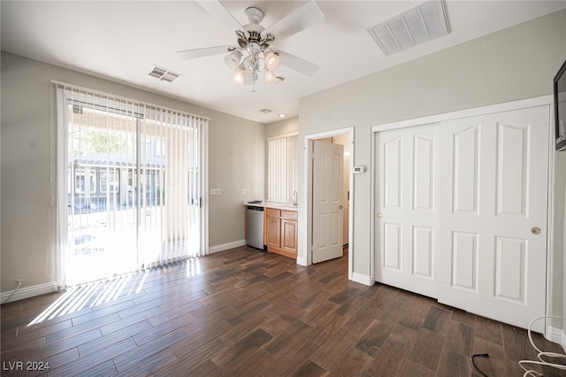 unfurnished bedroom featuring access to exterior, dark hardwood / wood-style floors, a closet, and ceiling fan