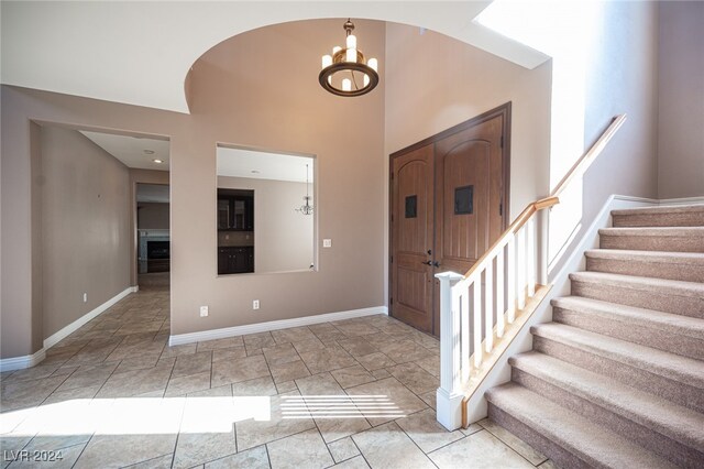 foyer with a chandelier and a high ceiling