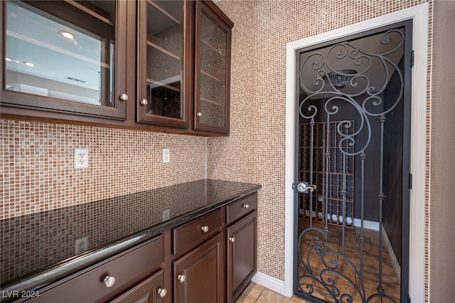 kitchen with dark brown cabinetry and decorative backsplash