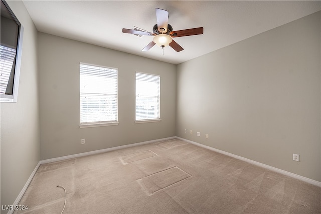 unfurnished room with ceiling fan and light colored carpet