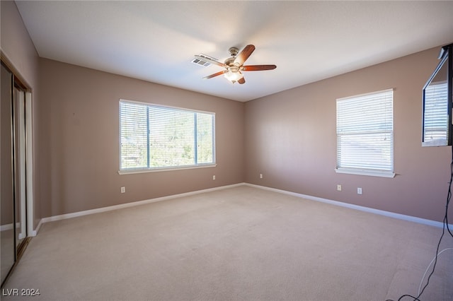 unfurnished bedroom featuring ceiling fan and light carpet