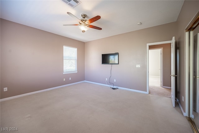 unfurnished bedroom with ceiling fan and light carpet