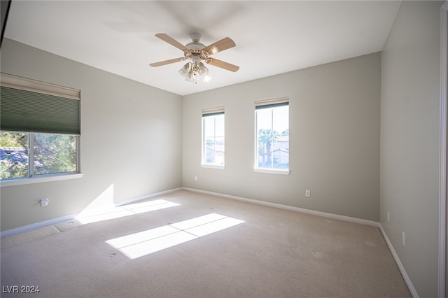 unfurnished room featuring light carpet and ceiling fan