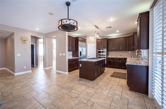 kitchen featuring tasteful backsplash, a center island, sink, and a wealth of natural light