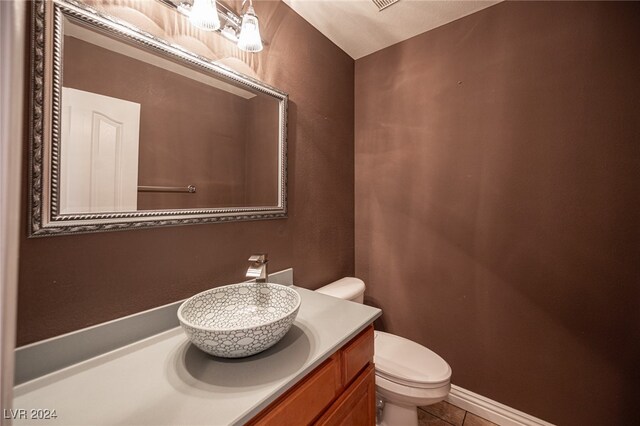 bathroom featuring vanity, toilet, and tile patterned floors