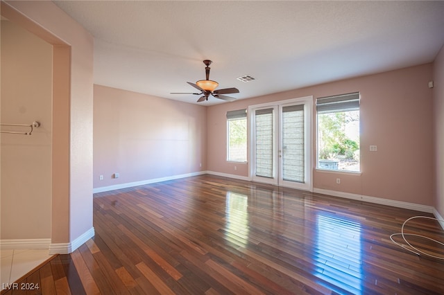 spare room with french doors, ceiling fan, and dark hardwood / wood-style floors