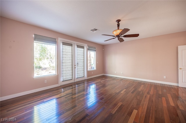 spare room with french doors, ceiling fan, plenty of natural light, and dark hardwood / wood-style flooring