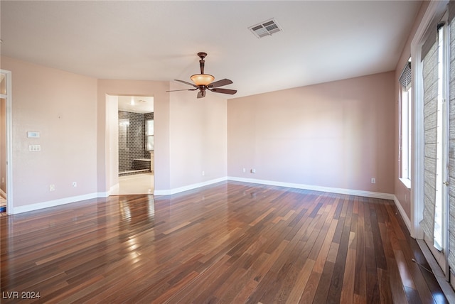 spare room featuring dark wood-type flooring and ceiling fan