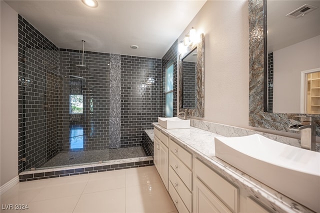 bathroom featuring vanity, tile patterned floors, and tiled shower