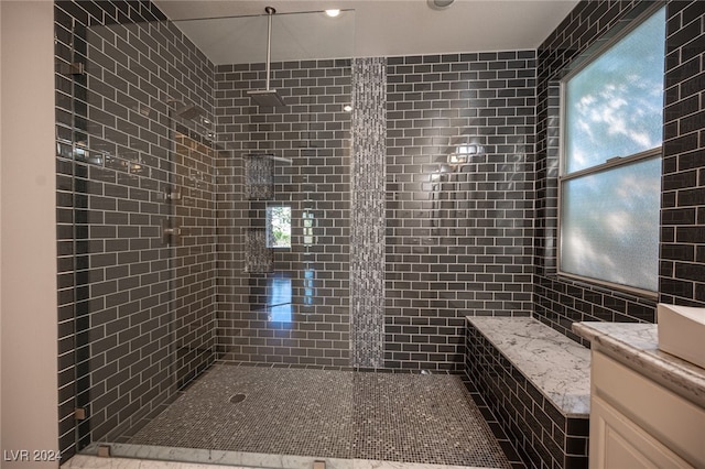 bathroom with vanity and a tile shower