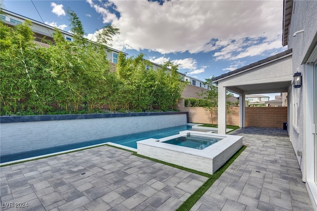 view of pool with an in ground hot tub and a patio area