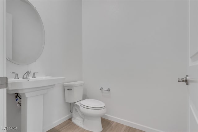 bathroom featuring sink, hardwood / wood-style floors, and toilet