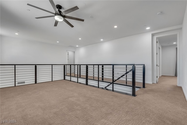 carpeted spare room with ceiling fan