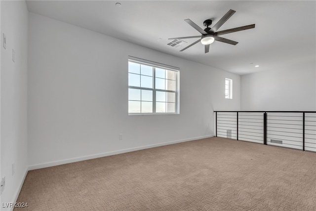 spare room with ceiling fan and carpet flooring