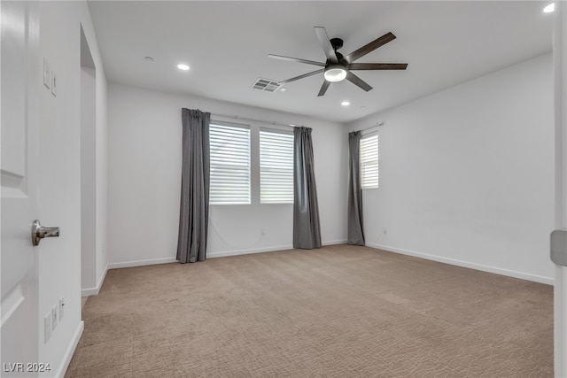 unfurnished room with light carpet and ceiling fan