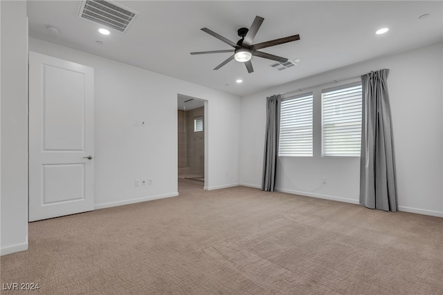 carpeted spare room with ceiling fan