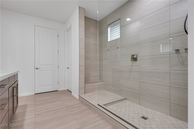 bathroom featuring vanity and tiled shower