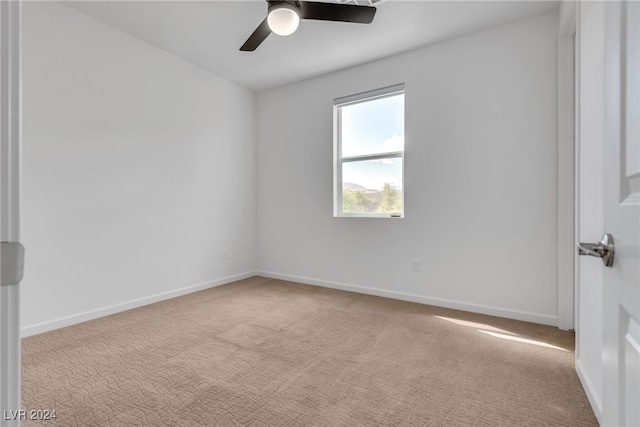 empty room featuring light carpet and ceiling fan