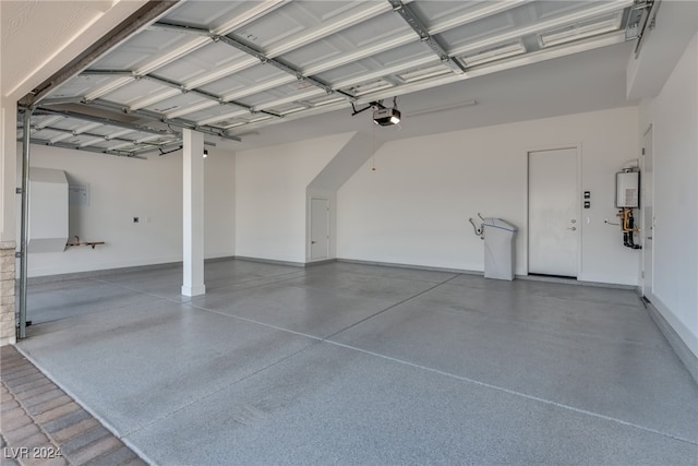 garage with a garage door opener and water heater