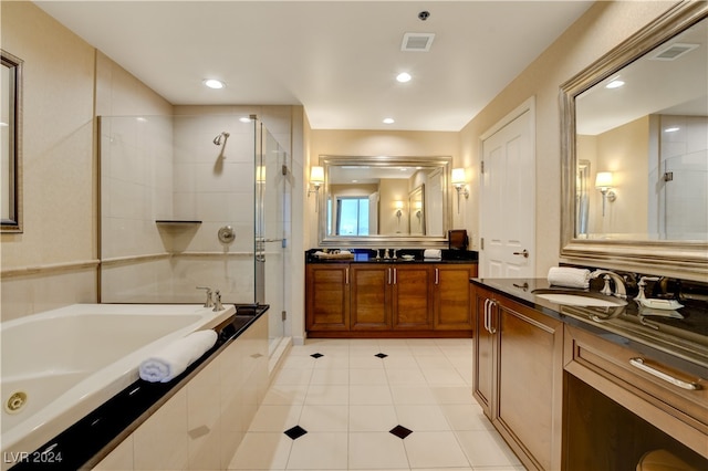 bathroom with independent shower and bath, vanity, and tile patterned floors