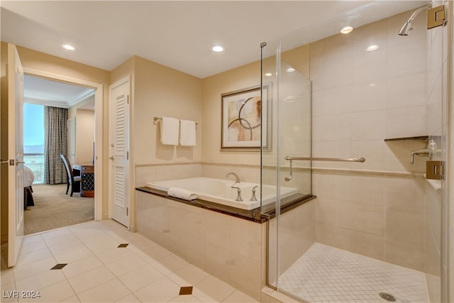 bathroom with tile patterned flooring, crown molding, and separate shower and tub