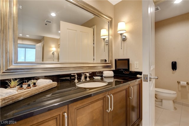 bathroom featuring vanity, toilet, and tile patterned floors