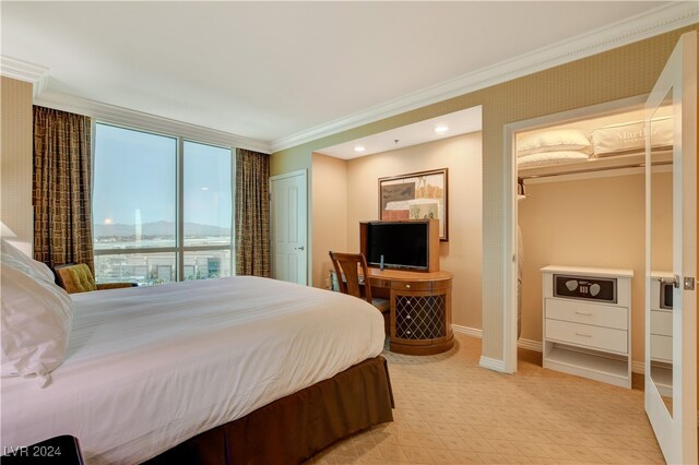 bedroom with a closet and crown molding