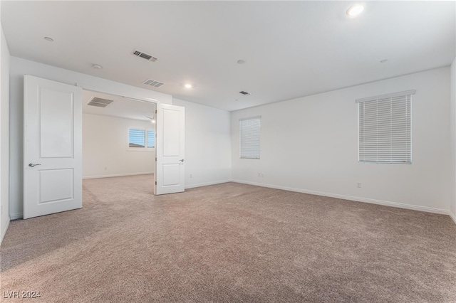 empty room featuring light colored carpet