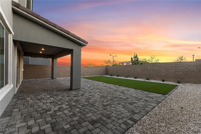 view of patio terrace at dusk