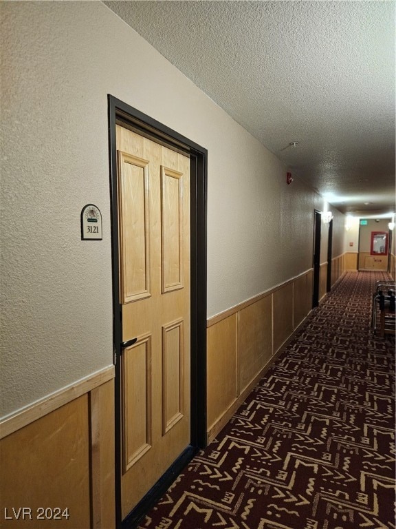 hallway featuring a textured ceiling