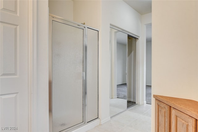 corridor with light tile patterned floors