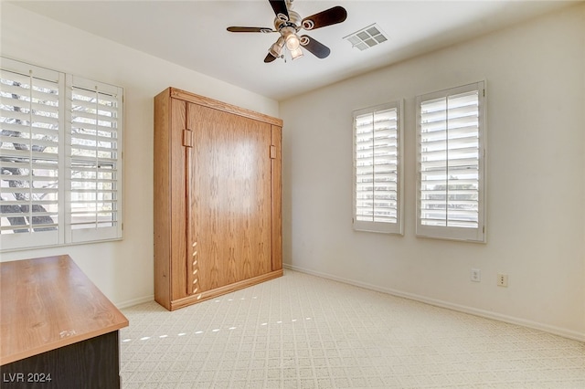 unfurnished bedroom with light carpet and ceiling fan