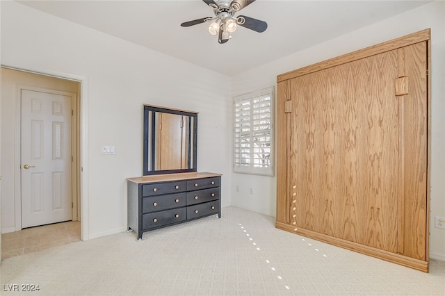 tiled bedroom featuring ceiling fan