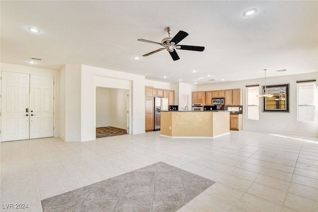 unfurnished living room with ceiling fan and light tile patterned floors