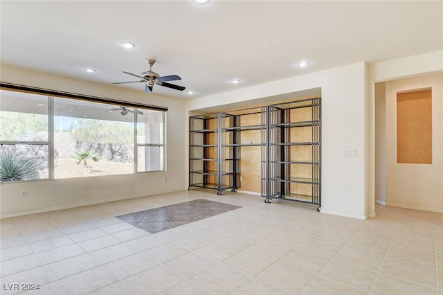 unfurnished room with ceiling fan and light tile patterned floors