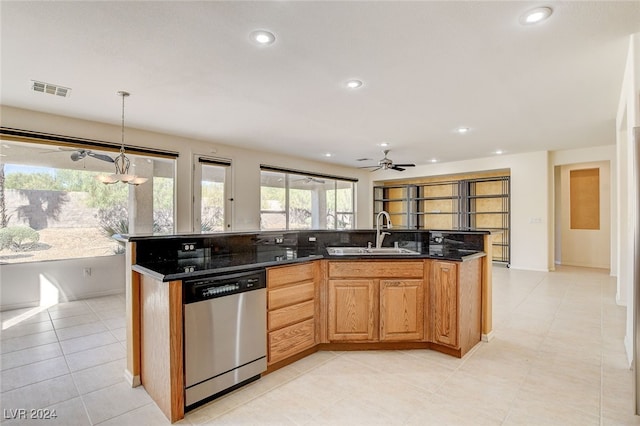 kitchen featuring hanging light fixtures, an island with sink, dishwasher, ceiling fan, and sink