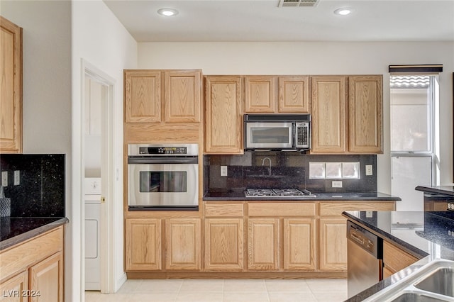 kitchen featuring stainless steel appliances, backsplash, light brown cabinets, and light tile patterned floors