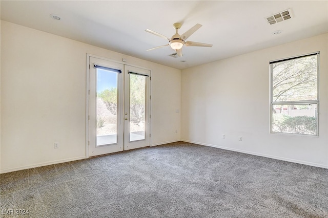 empty room with carpet flooring and ceiling fan