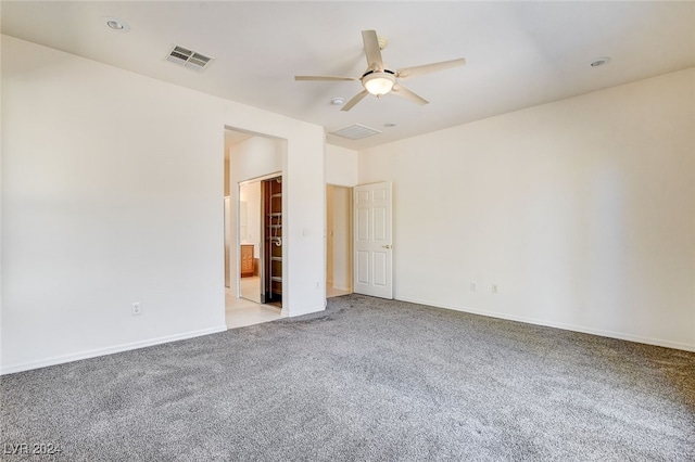 spare room featuring ceiling fan and light colored carpet