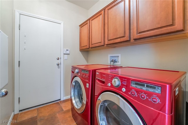 laundry area with washing machine and dryer and cabinets