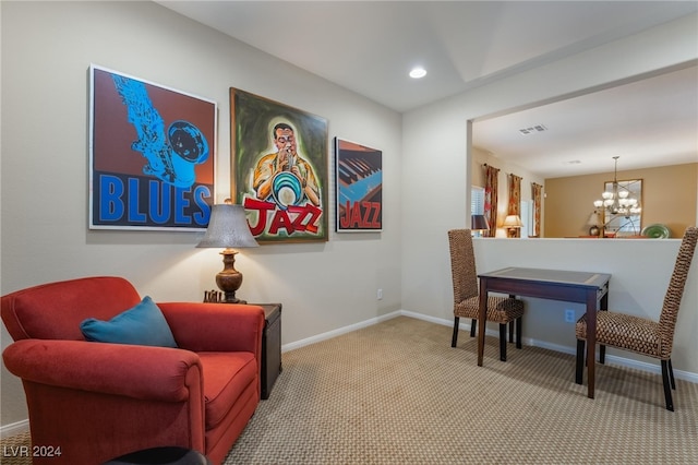 living area featuring light carpet and an inviting chandelier