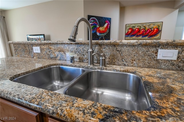 interior details featuring stone countertops and sink