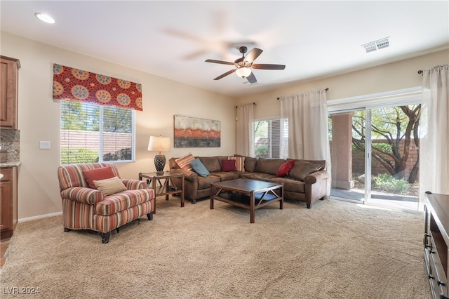 carpeted living room with ceiling fan